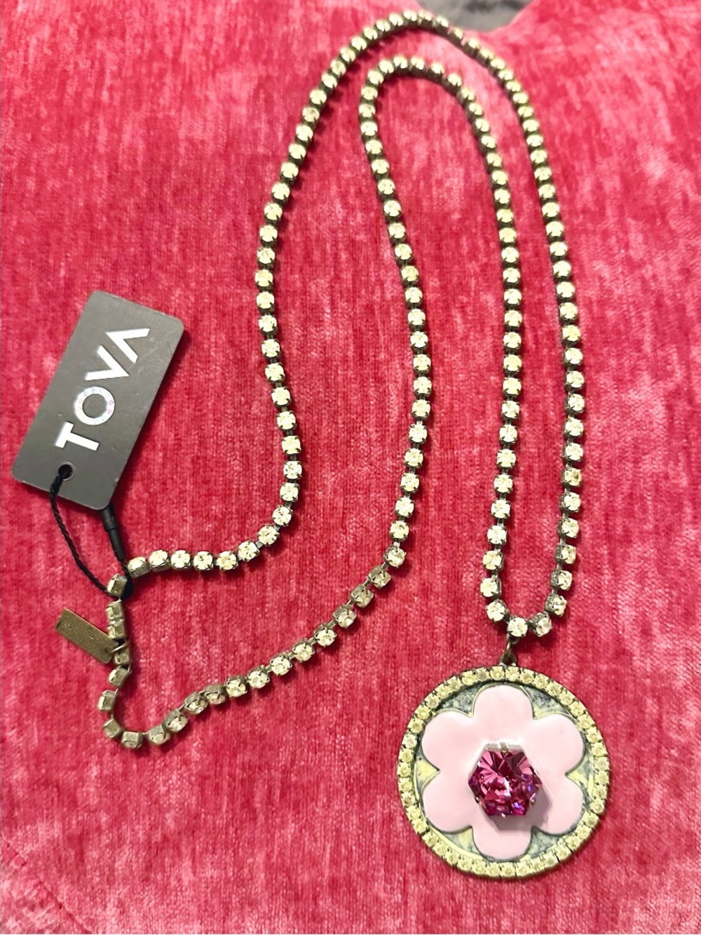 TOVA Long Pink Flower Necklace, round pendant with a pink enamel floral design